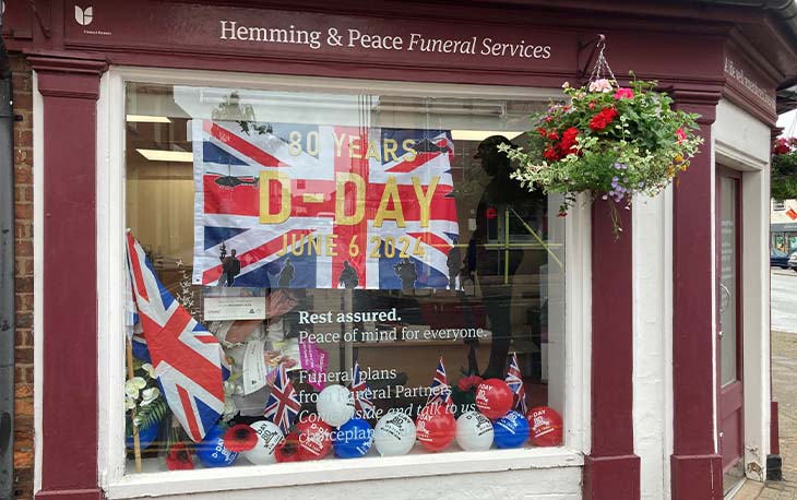 Window display with Greta Britain flag and red, white and blue.